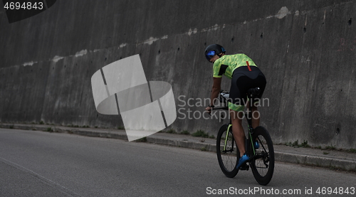 Image of triathlon athlete riding a bike on morning training