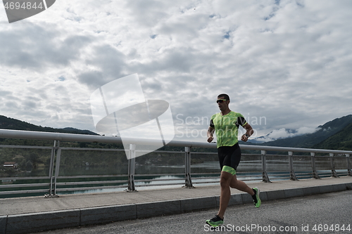 Image of triathlon athlete running on street