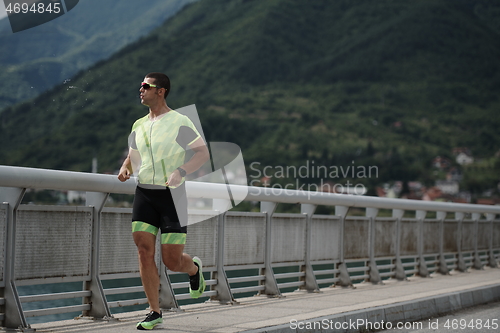 Image of triathlon athlete running on street