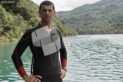 Image of triathlete swimmer portrait wearing wetsuit on training