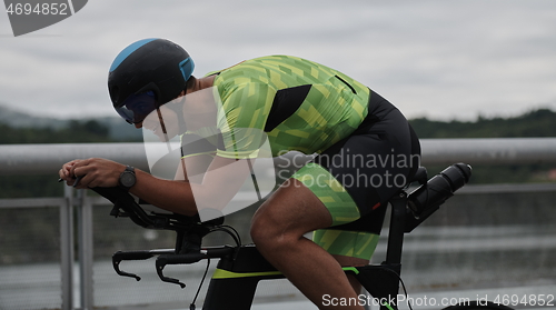 Image of triathlon athlete riding a bike on morning training