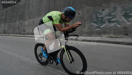 Image of triathlon athlete riding a bike on morning training