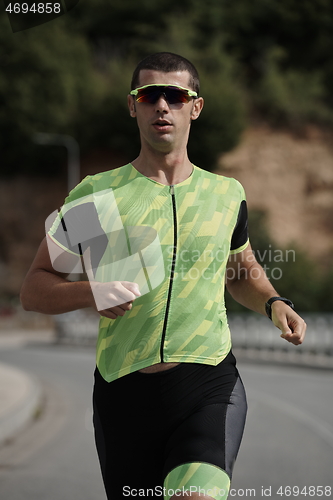 Image of triathlon athlete running on street