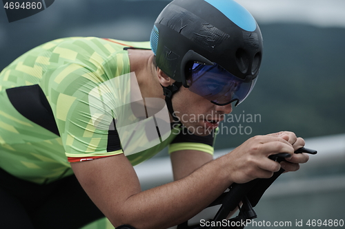 Image of triathlon athlete riding a bike on morning training