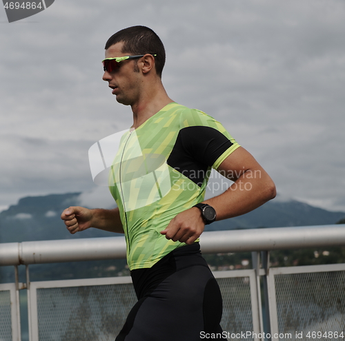 Image of triathlon athlete running on street