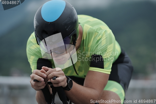 Image of triathlon athlete riding a bike on morning training