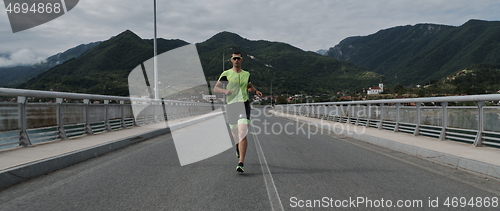 Image of triathlon athlete running on street