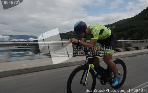 Image of triathlon athlete riding a bike on morning training