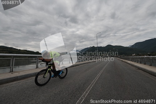 Image of triathlon athlete riding a bike on morning training