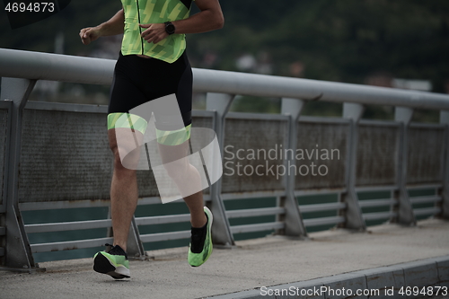 Image of triathlon athlete running on street