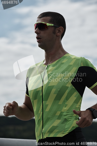 Image of triathlon athlete running on street