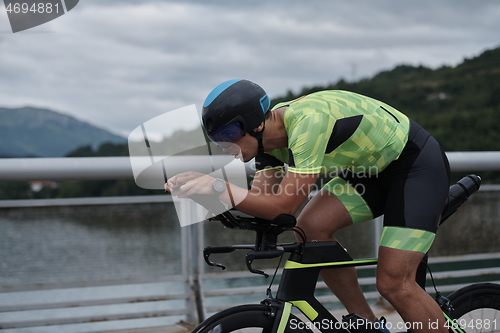 Image of triathlon athlete riding a bike on morning training