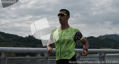 Image of triathlon athlete running on street