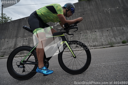 Image of triathlon athlete riding a bike on morning training