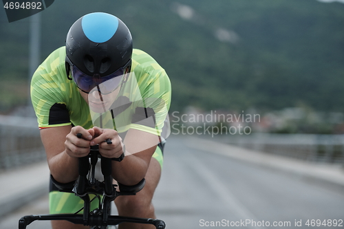 Image of triathlon athlete riding a bike on morning training