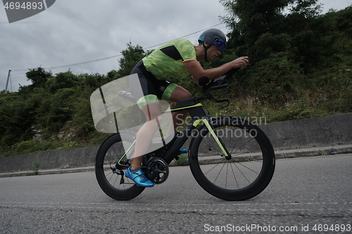 Image of triathlon athlete riding a bike on morning training