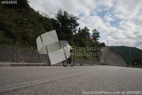 Image of triathlon athlete riding a bike on morning training