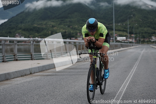 Image of triathlon athlete riding a bike on morning training