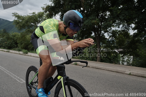 Image of triathlon athlete riding a bike on morning training