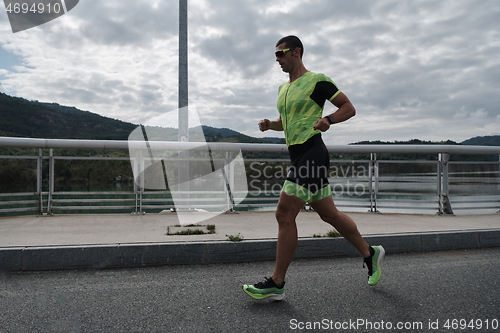 Image of triathlon athlete running on street