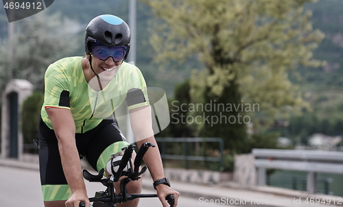 Image of triathlon athlete riding a bike on morning training