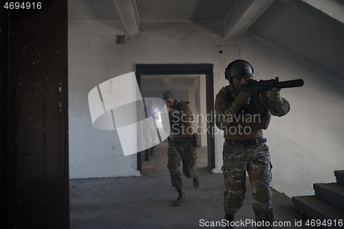 Image of military troops in action urban environment