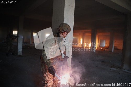 Image of military troops in action urban environment