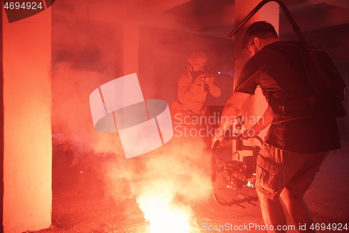 Image of Videographer Taking Action Shoot of Soldiers in Action urban environment