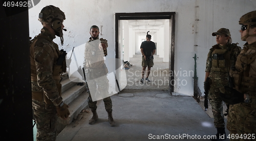 Image of Videographer Taking Action Shoot of Soldiers in Action urban environment