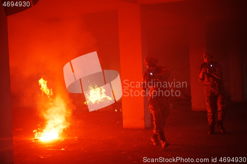 Image of military troops in action urban environment