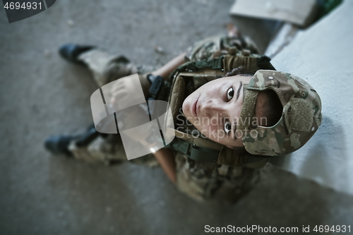 Image of military female soldier having a break