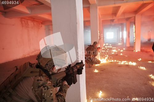 Image of military troops in action urban environment