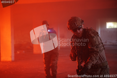 Image of military troops in action urban environment