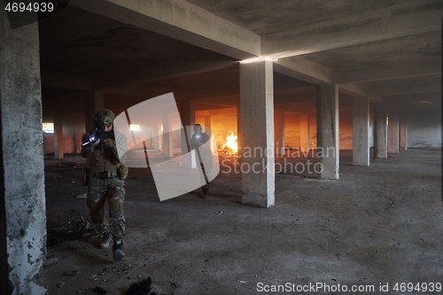 Image of military troops in action urban environment