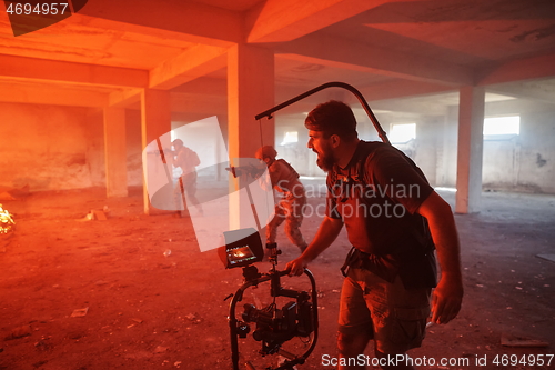 Image of Videographer Taking Action Shoot of Soldiers in Action urban environment