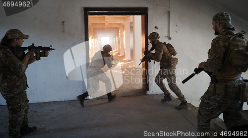 Image of military troops in action urban environment