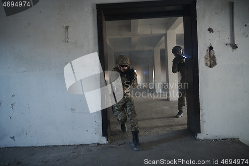 Image of military troops in action urban environment