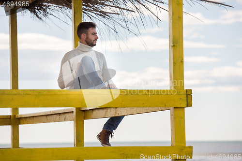 Image of Young man enjoying the warm autumn day