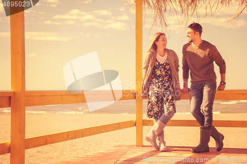 Image of Couple chating and having fun at beach bar