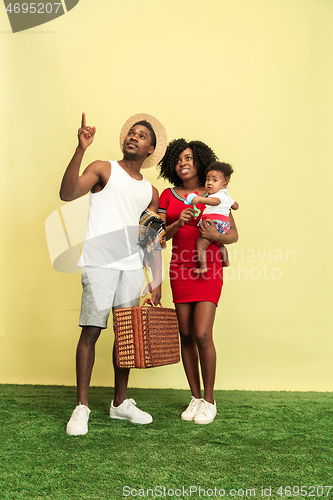 Image of Happy family having picnic at studio