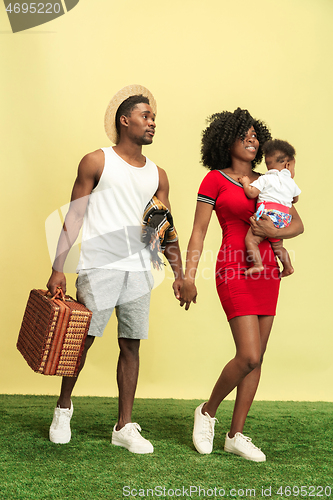 Image of Happy family having picnic at studio