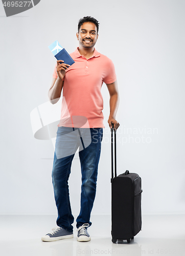 Image of indian man with travel bag passport and air ticket