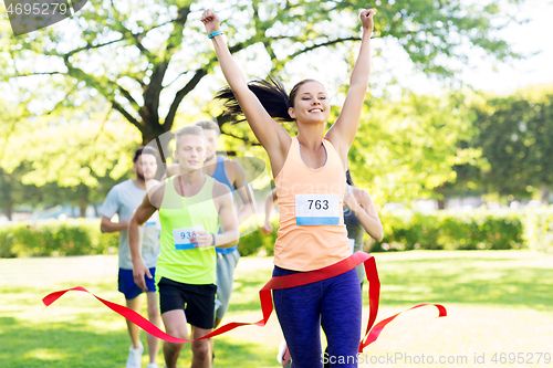 Image of happy young female runner on finish winning race