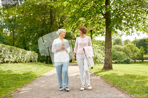 Image of senior women or friends drinking coffee at park