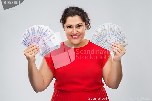 Image of happy woman holding hundreds of money banknotes