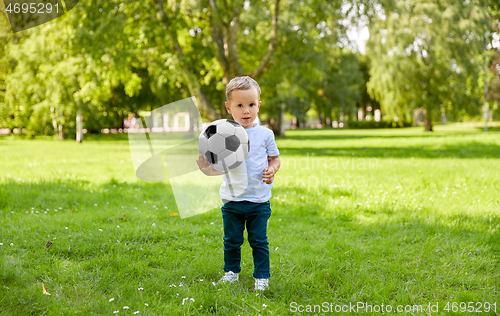 Image of little baby boy with soccer ball at summer park