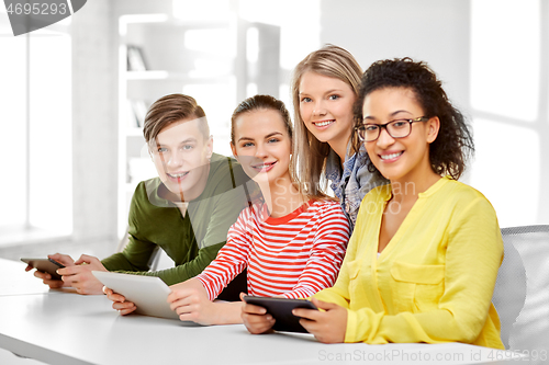 Image of high school students with tablet computers