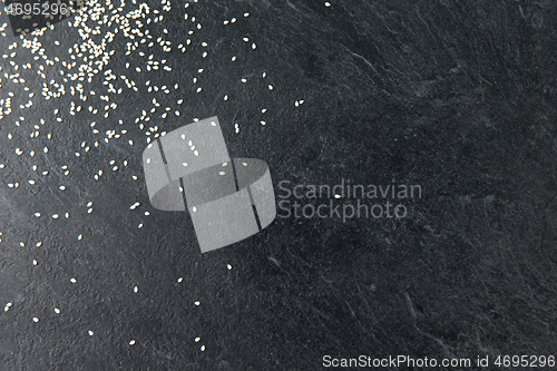 Image of sesame seeds on slate stone background