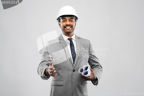 Image of male architect in helmet giving hand for handshake