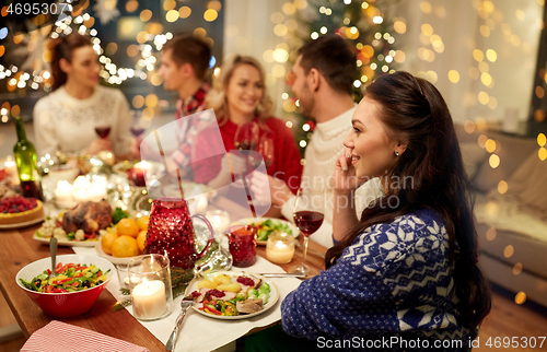 Image of woman calling on smartphone at christmas dinner